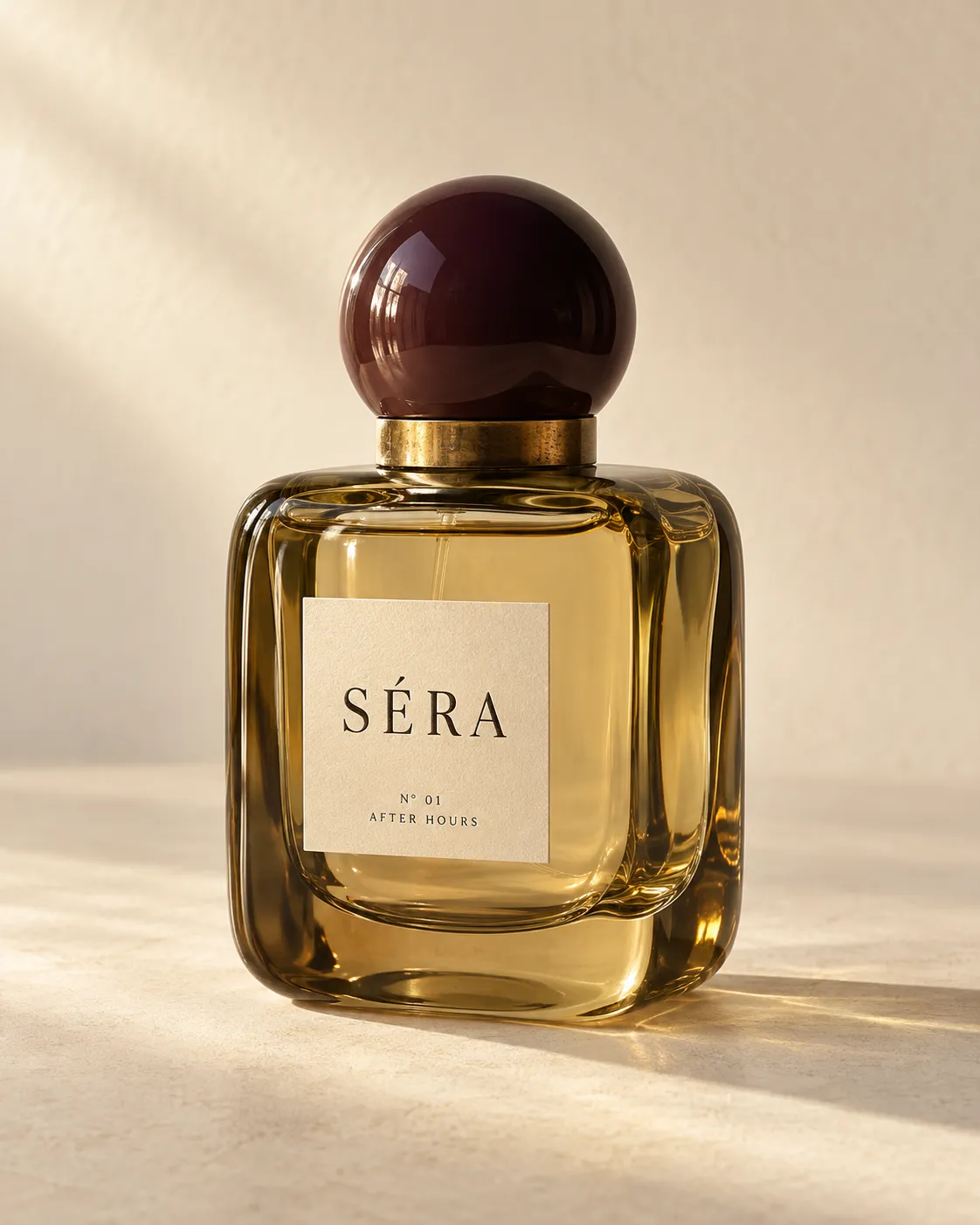 SÉRA fragrance in an amber glass bottle with a round plum cap